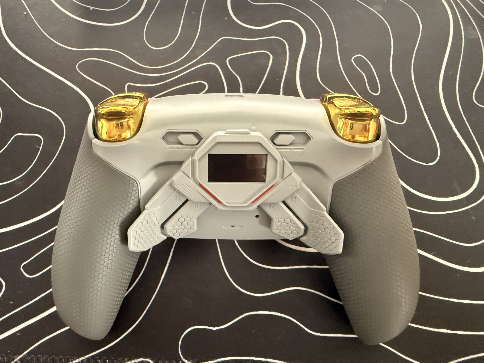 The back of my modified PS5 controller showing the installed rear paddles and gold triggers